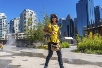 Female tourist exploring the vibrant east village neighborhood in calgary, enjoying the cityscape