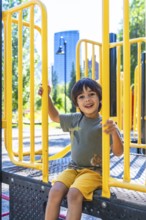 Happy child smiling and playing joyfully on a vibrant playground structure in calgary, canada,