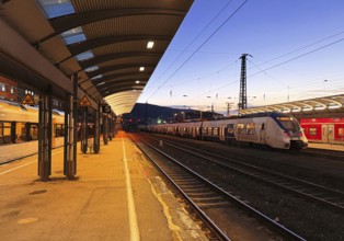 Deserted platform with regional express in the evening, central railway station, Hagen, North