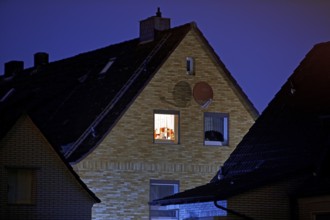 Illuminated window of a residential building in a settlement at night, Witten, Ruhr region, North