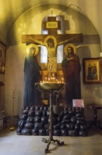 Depiction of the Crucifixion with Burning Candles in a Dark, Silent Church Room, Bodbe Monastery,
