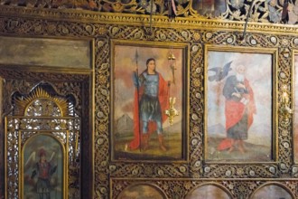Richly decorated church icons on a wall, with golden ornaments and religious figures, Bodbe