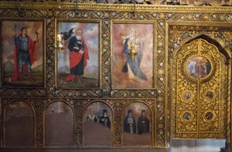 Iconic wall decoration with religious motifs and golden details in a church, Bodbe monastery,