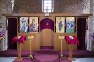 Orthodox iconostasis with richly decorated icons and cross, intricately crafted wood, church,