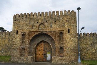 Historic fortress with high archway and massive stone walls, medieval charm, entrance gate, Batonis