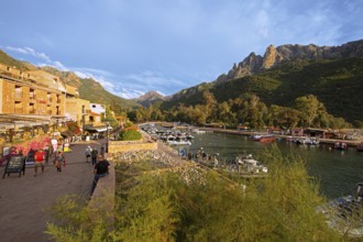 Boats in Port de Porto or Port on the Porto River, Capu d'Orto Mountains in the back, afternoon