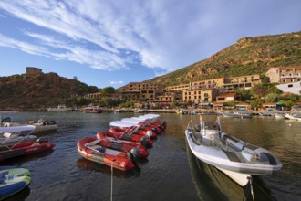 Colourful boats in Port de Porto or Port on the Porto River, behind the Genoese Tower, Porto, Ota,