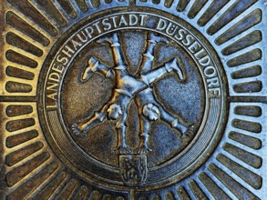 Manhole cover with classic depiction of the racket, landmark of the state capital Düsseldorf, North