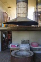 Large traditional oven with extractor hood in a rustic industrial setting, bakery, Badiauri,