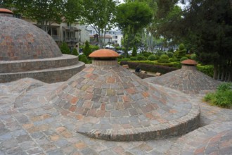 Dome formations and green surroundings with classic brick elements, sulfur baths, Abanotubani spa