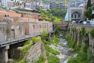 Historic bridge over a river surrounded by lush vegetation, Leghvtakhevi river and gorge, Orbeliani