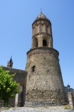 Close-up of a medieval tower under bright blue sky in an old town, St. George Church, St. George,