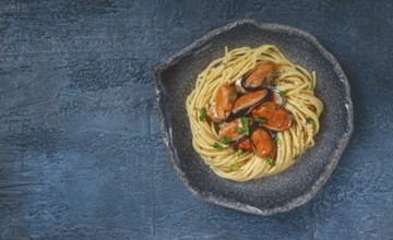 Spaghetti with mussels, without shell, pasta with peeled mussels, in carbonara sauce, micro-greens,