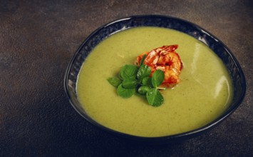 Pea cream soup, with shrimp, green soup, homemade, top view, no people