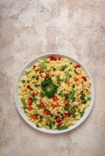 Couscous with vegetables, paprika, carrots, string beans, corn, homemade, top view, no people