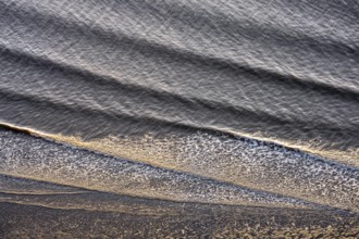Small waves run on the beach