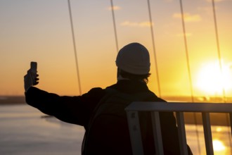 Selfie at sunset on the viewing platform of the Atlantic Sail City Hotel Hochhaus, view over the
