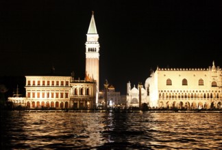 Illuminated Piazzetta San Marco with the granite columns, the Biblioteca Nationale Marciana, the