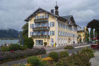 Historic town hall on the banks of Tegernsee, flower decorations in the foreground, town of