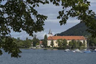 Parish Church of St. Quirinus, Tegernsee Abbey, Castle with Braustüberl, framed with branches,