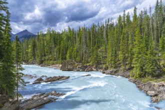 Turquoise water flows through the bow river natural bridge in banff national park, alberta, canada,