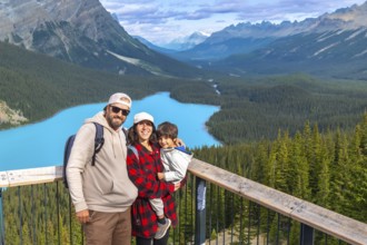 Tourists admiring stunning turquoise waters of peyto lake, surrounded by majestic canadian rockies