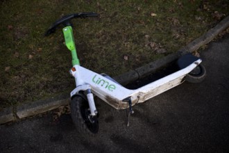Carelessly left on the side of the road, e-scooter, scooter, in the bike rental company Lime,
