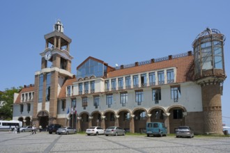 Historic building with clock tower and vehicles in the foreground under clear sky, City Hall,