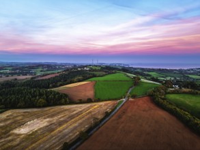 Sunset of Devon Farms and Fields over Berry Pomeroy from a drone, Totnes, England, United Kingdom