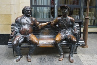 Two bronze sculptures of men on a bench in humorous depiction, 'Two Old Friends, Chavteli Street,