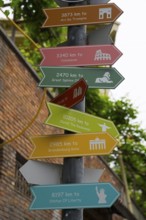 Colourful signpost shows distances to famous sights in the world, Tbilisi, Tbilisi, Georgia