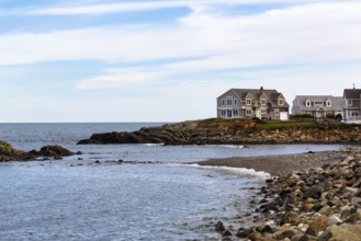 Idyllic coastal scene, rocky coastline and distinctive houses, New England style architecture,