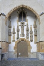 Church portal with crucifix and figures, monastery church decorations built in the 15th century,