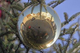 Reflection of the market square with hospital courtyard in a ball, Christmas tree, Christmas