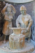 Blacksmith working metal on an anvil at the guild fountain by Bonifatius Stirnberg 1983, modern