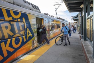 Arvada, Colorado - Passengers board Denver's light rail train system at the Olde Town Arvada