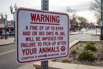 Arvada, Colorado - A sign in Olde Town Arvada lists the consequences for failing to pick up your