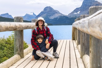 Tourists relishing the stunning scenery of bow lake in banff national park, alberta, canada,