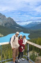 Tourists are admiring the stunning turquoise waters of peyto lake, surrounded by majestic canadian