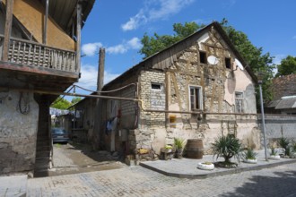 Traditional half-timbered stone house with a veranda in a quiet village street, traditional German