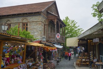 Busy old town street with traditional buildings and market stalls selling souvenirs, Mtskheta,