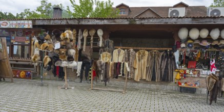Market stall with fur hats and coats surrounded by souvenirs and traditional style, Mtskheta,