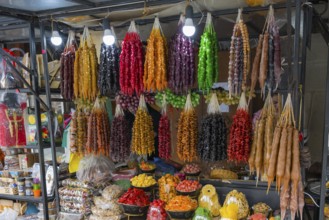 Diverse market stand with colorful hung Georgian sweets and dried fruits, Churchkhela, Georgian