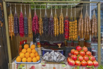 Colourful fruit and candy display with hanging goodies, Churchkhela, Georgian confections,