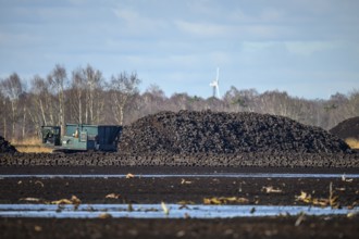 Layered peat sod Peeling of a high-moor black peat in cloudy skies with earthy colors and natural