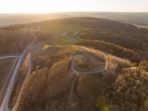 Landscape at sunset with hills and dense forest, future PV building on old deposit, Lindenrain