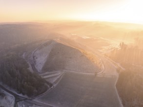 Hill in foggy landscape at sunrise, with surrounding roads and quiet atmosphere, future PV