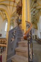 Detailed view of a stone spiral staircase leading to the pulpit with artistic carvings in a church,