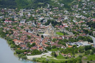 Panoramic view of a riverside town surrounded by green hills, view of Mtskheta, Mtskheta,