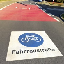 Large marking on road painted symbol for road signs 244.1-40 Start end of a bicycle road, behind it